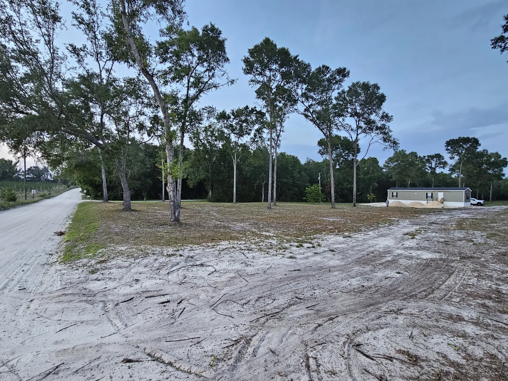 Rural property access driveway with land clearing and mobile home site prep